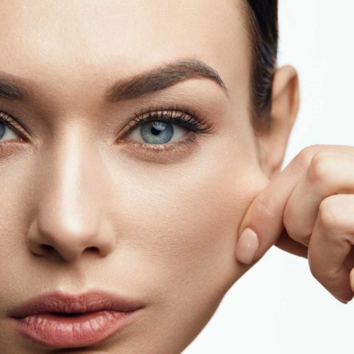 femme tire la peau du visage