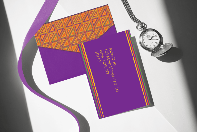 Purple custom envelope with geometric patterns next to a silver pocket watch and silk ribbon.