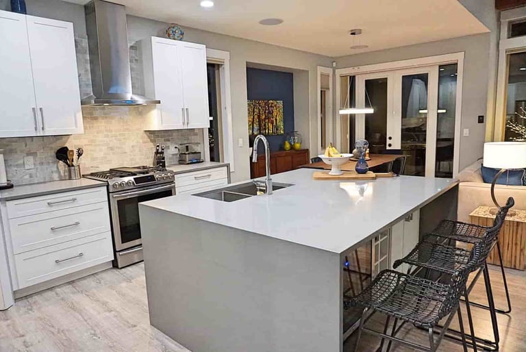 High gloss countertop and white kitchen cabinets euro-style in a kitchen in lake country