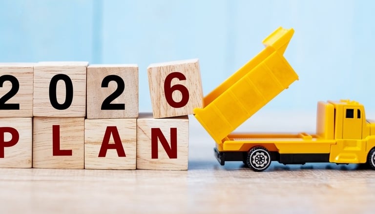 a toy truck with a dump truck in the background