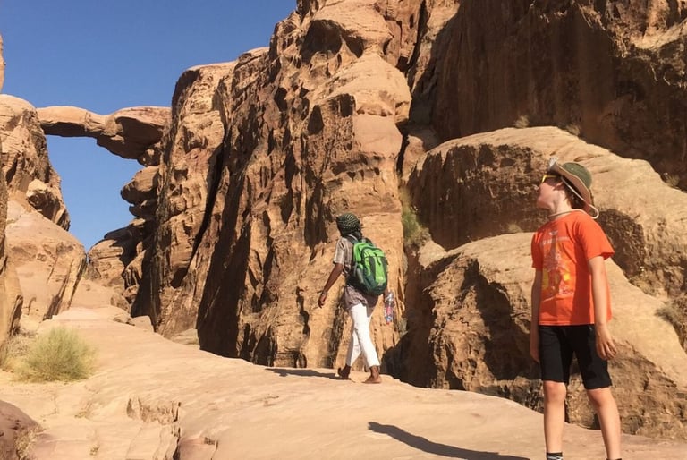 two people standing in a canyon