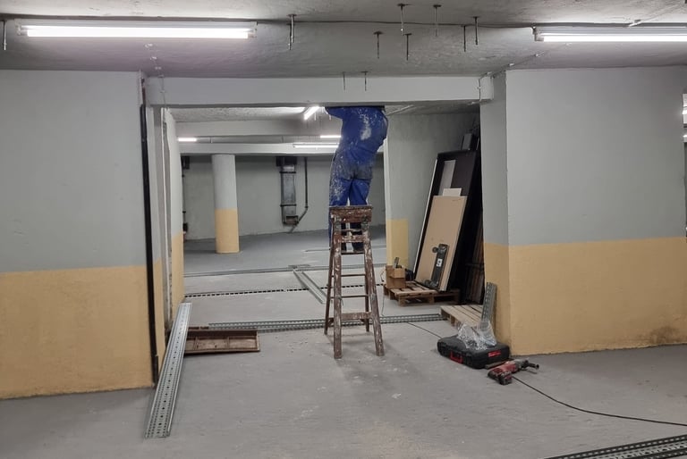 a man working in a commercial space with a ladder
