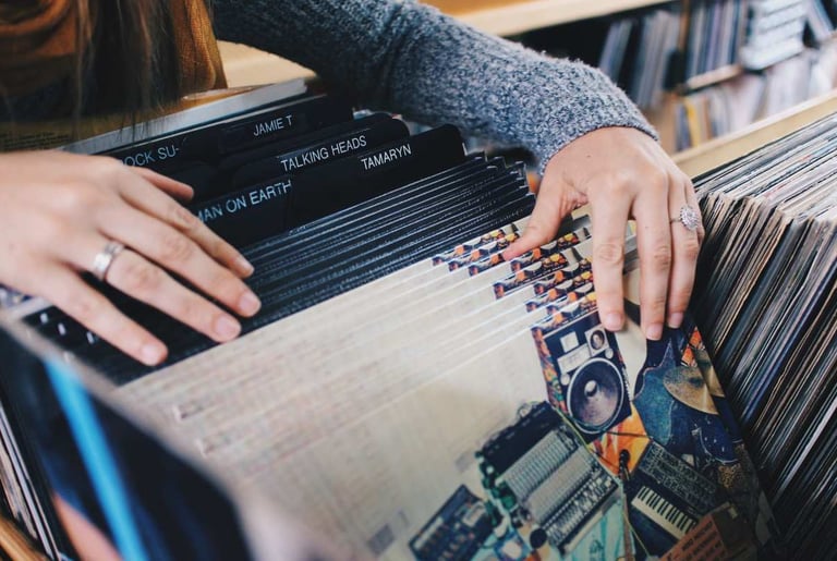 Person browsing through vinyl records