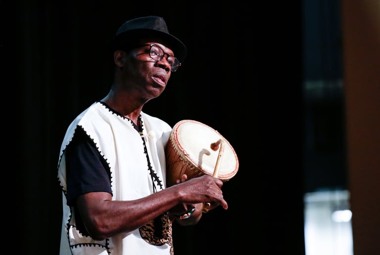 artist Kofi Dennis drums during a performance (credit: Zaw Lin)