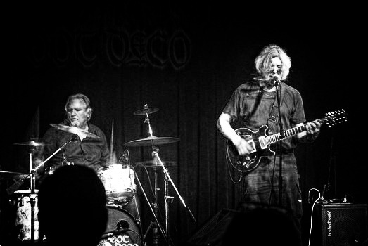 photo of guitarist and drummer playing