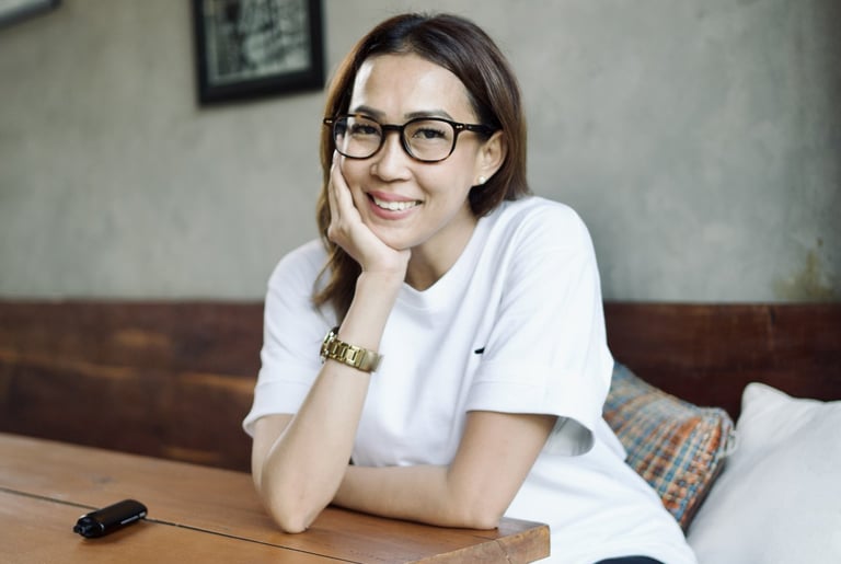 a woman sitting on a bench in a restaurant