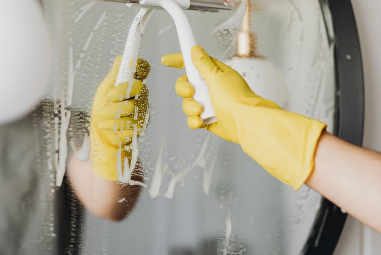 cleaning mirror in a bathroom