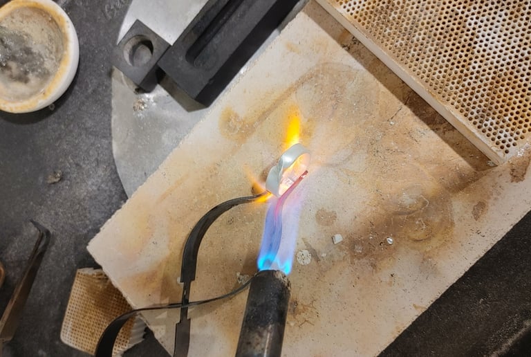 Pure silver being soldered and hand-formed into shape.