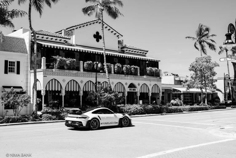 a porsche passing by a hotel on 5th avenue in naples florida