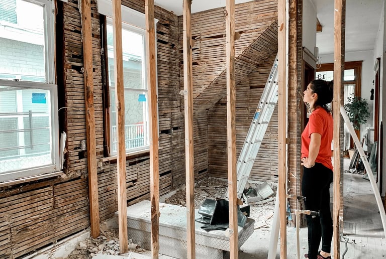 a woman standing in a room with a ladder