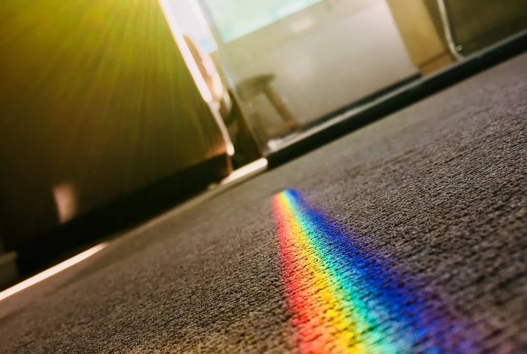 a rainbow - colored rainbow - colored light shining through a rainbow - colored light