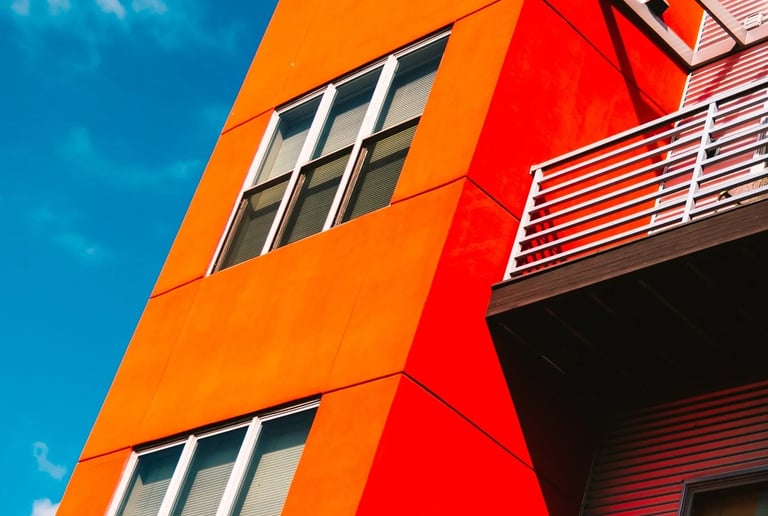 a red building with a balcony and a balcony