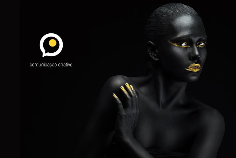 a woman with black and gold makeup and gold makeup