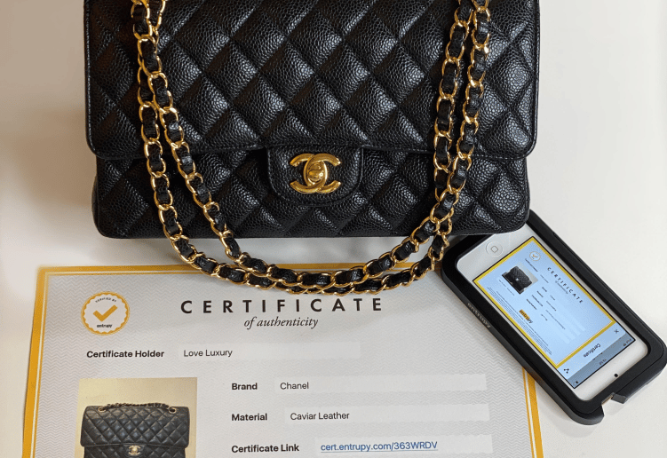 a black Chanel handbag with original documentation and certificate of authenticity