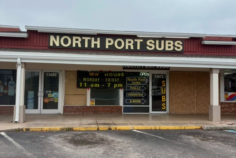 Storefront of North Port Subs restaurant offering Philly cheesesteak and sub sandwiches.