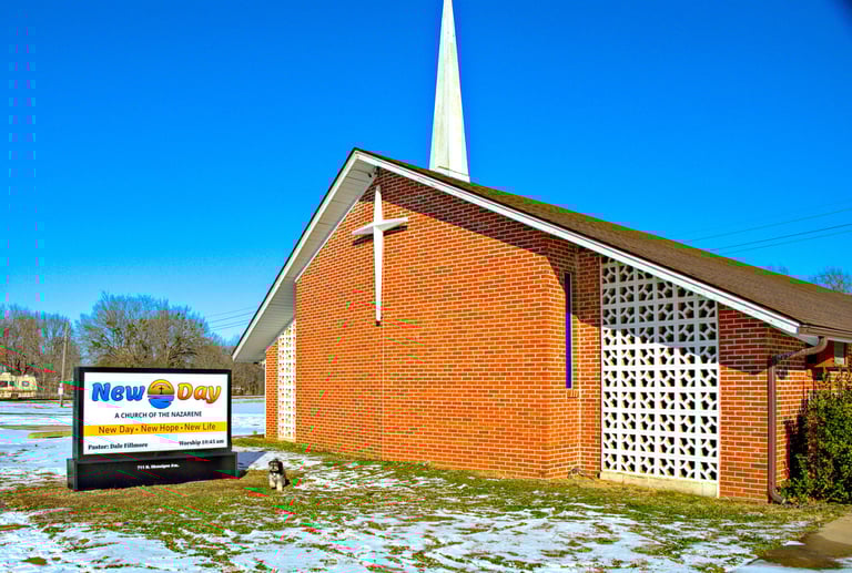 Our church with our new sign, photobombed by the Pastor's dog, Scamp.