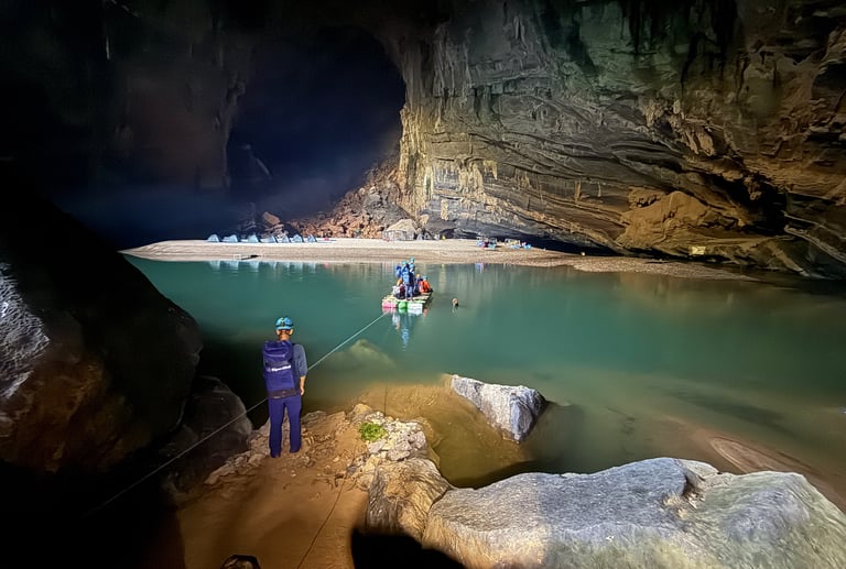 crossing Hang En cave lake in a raft, ke bang national park Vietnam