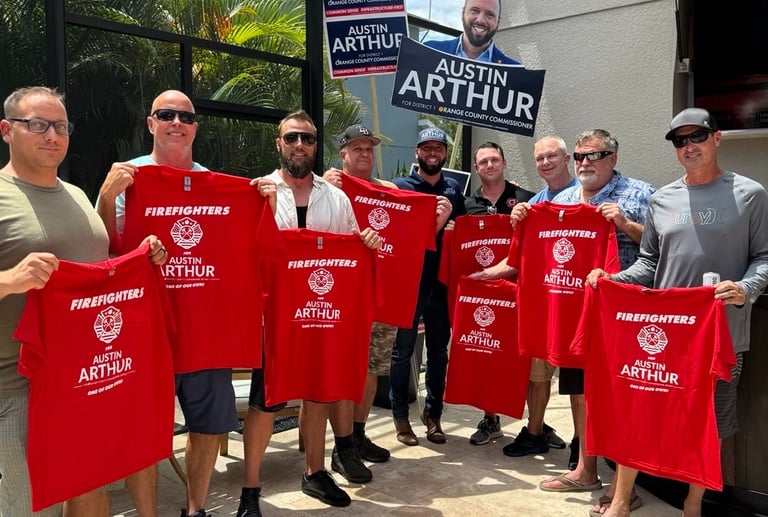 Firefighters showing support for Austin Arthur by holding Firefighters for Austin Arthur shirts in C