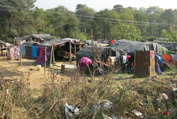Small slum in Himachal Pradesh. Black tarpaulined dwellings.