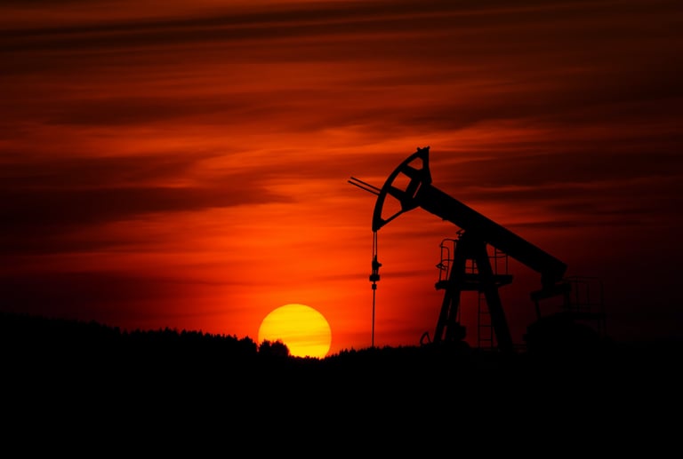 a large oil pump in the middle of a sunset