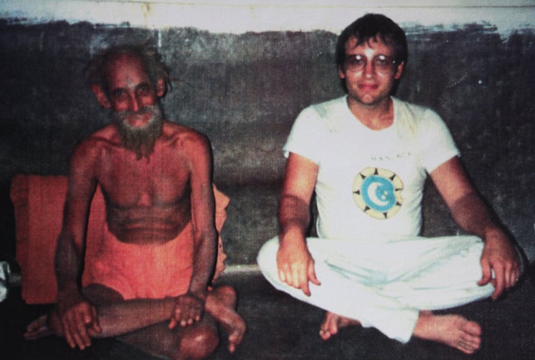 a man sitting on the floor with a beardless man