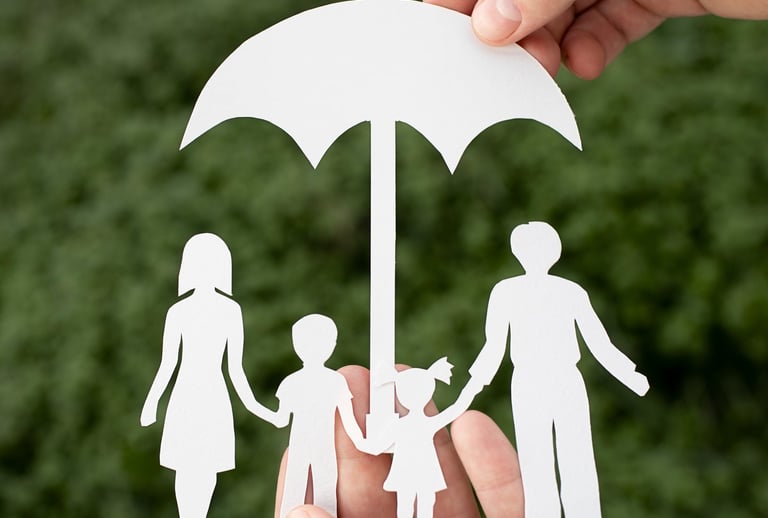 a person holding a paper cutout of a family