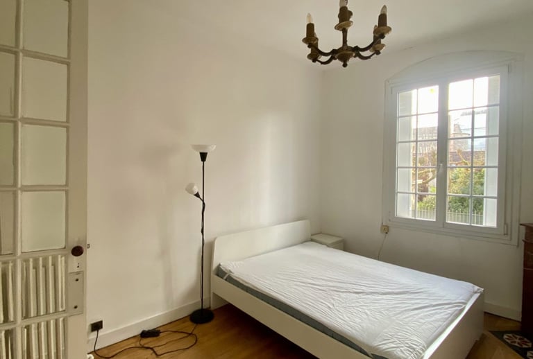 a bed in a room with a chandelier and a chandelier