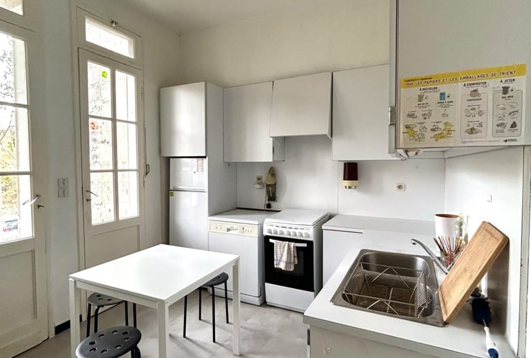 a kitchen with a table and chairs and a stove