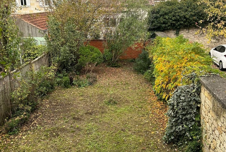 a car parked in a yard with a car parked in the driveway
