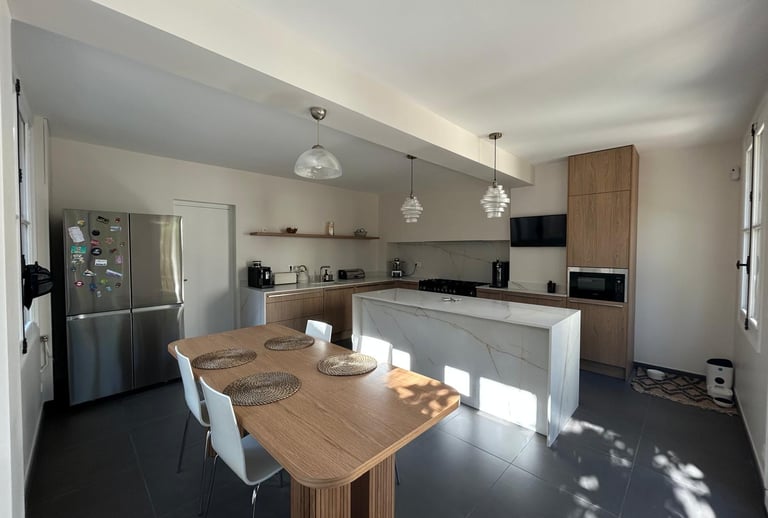 a kitchen with a table and chairs and a refrigerator