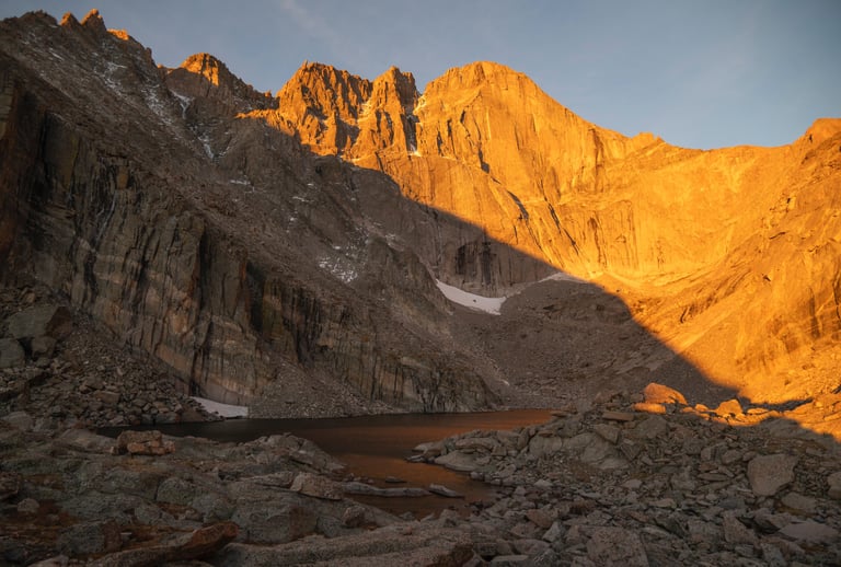 Longs Peak and chasm Lake glow brilliantly during summer sunrise