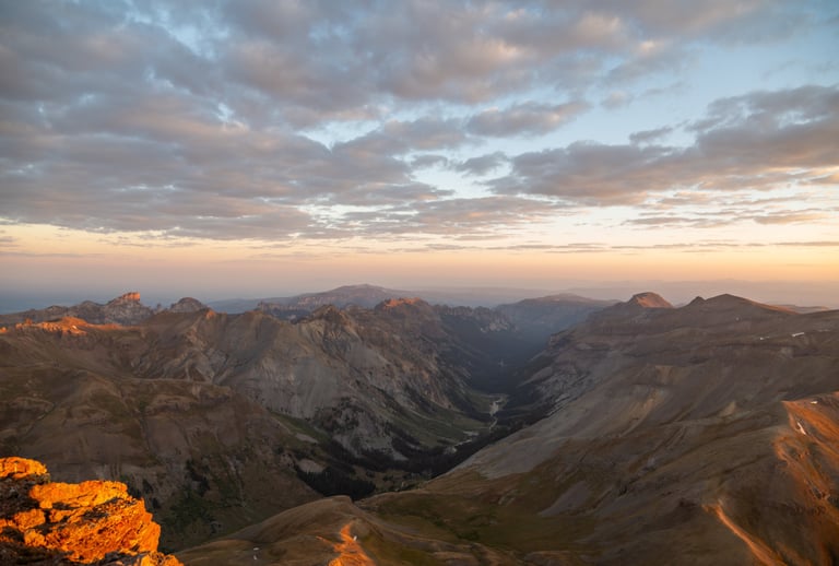 Sunrise from Uncompahgre Peak summit, view of San Juan Mountain peaks and valleys