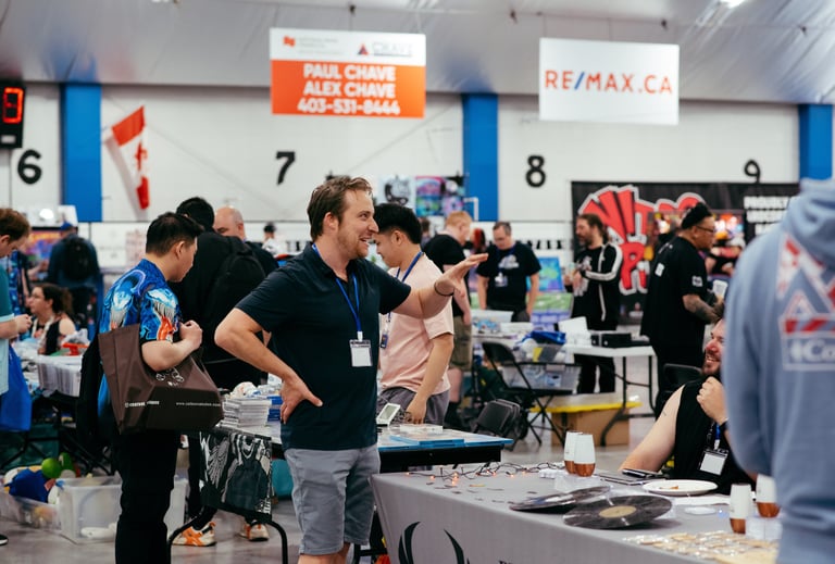 A volunteer smiles and gestures as he excitedly talks with a vendor at the event