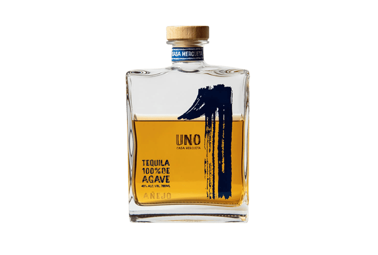 a bottle of uno tequila Añejo - premium tequila añejo