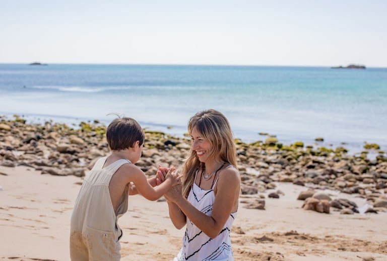 a boy and girl playing with a kite