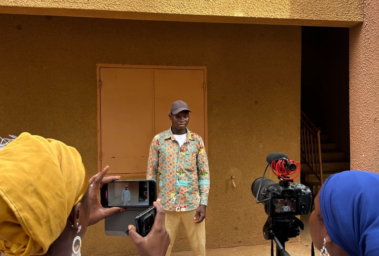 Kofi Dotse behind youth storytellers undertaking a field exercise