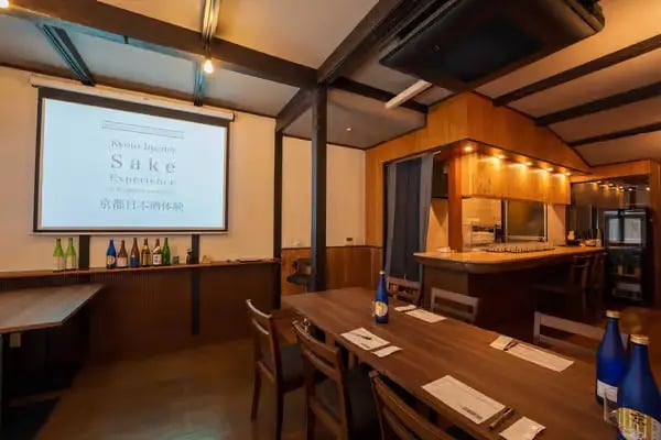 Kyoto insider sake experience venue with projector screen and tasting tables