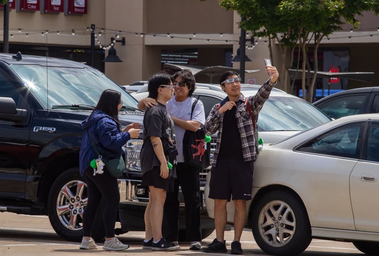 Four North Texas students play around and hang out in the 85C Bakery Cafe parking lot. Photo by Taylor Pleasant