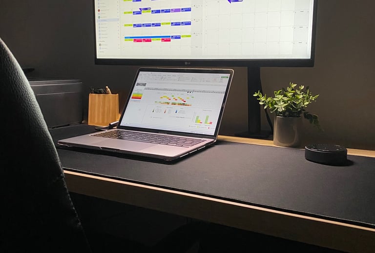 Modern minimalist home office setup with ultrawide monitor, laptop, and LED desk screen bar.