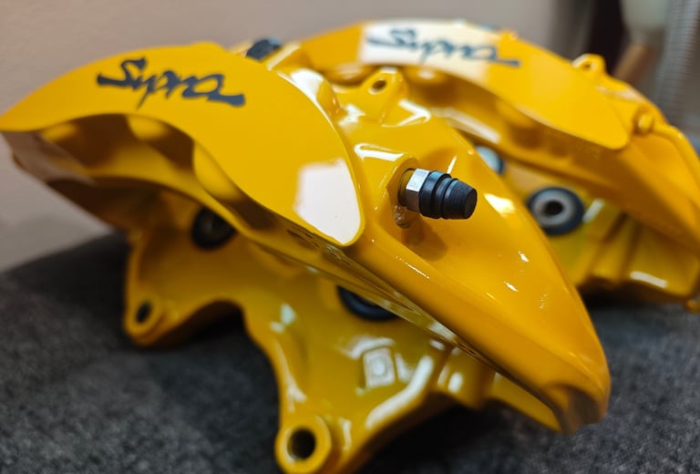 Modified CTSV calipers prepared in Signal Yellow for a MKIV Supra