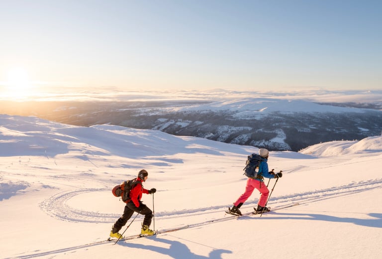 two people ski touring in the snow