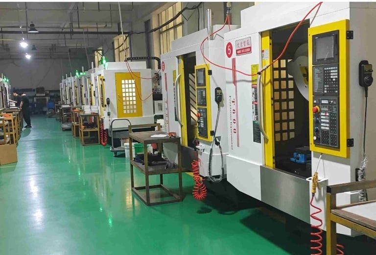 Industrial factory floor with a row of high-precision CNC milling machines for metal parts manufacturing.