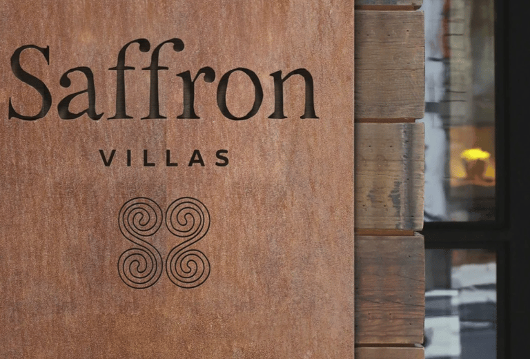 closup of Saffron Villas logo in wood
