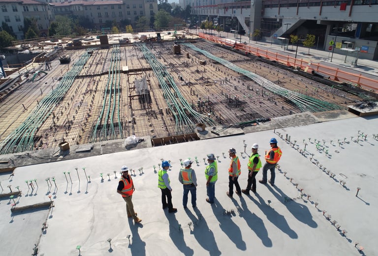 a group of construction workers standing on a roof top