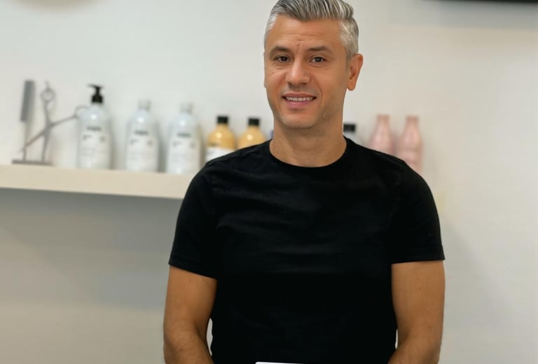 a man in a black shirt and a laptop