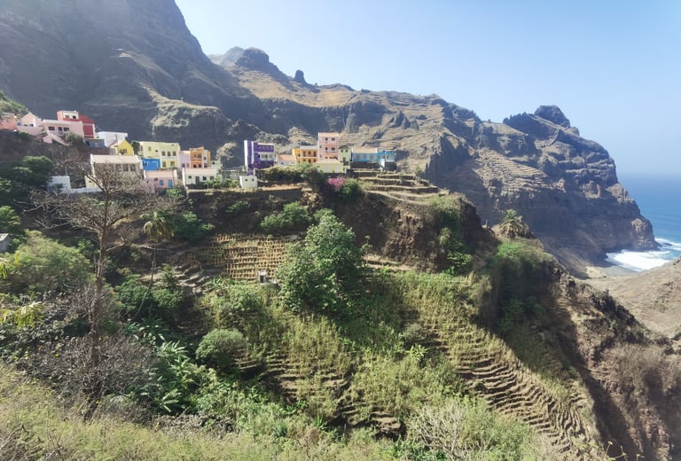 Colorful houses on a steep terraced mountain slope overlooking the Atlantic coast in Cape Verde.