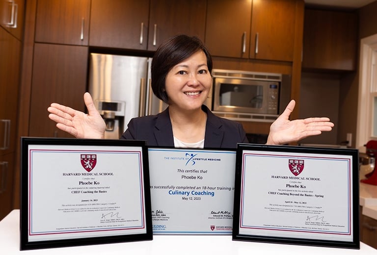A woman confidently showing three framed certificates with her hands