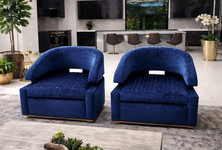 Pair of custom blue upholstered accent chairs with curved backs and matching ottomans