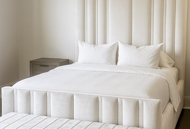 Bedroom with vertical upholstered wall panels in a soft neutral tone by Solo Home Decor