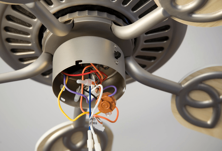 a fan with wires and wires attached to a ceiling fan